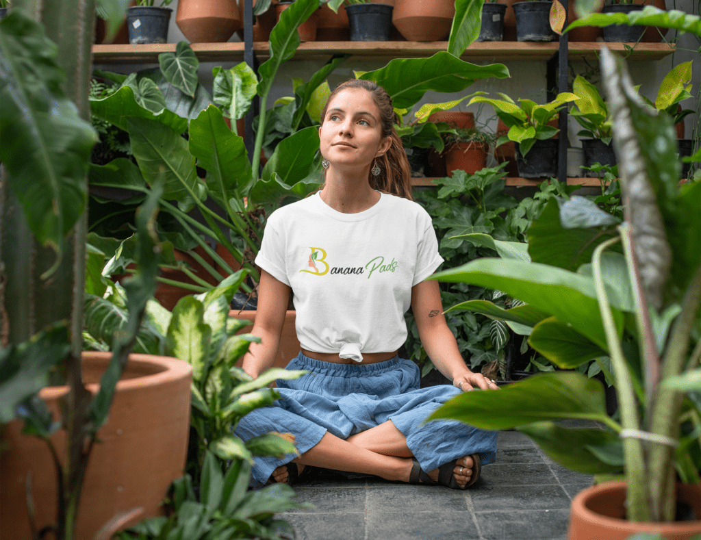 T Shirt Mockup Of A Relaxed Young Woman Sitting In A Greenhouse 27084 1 1024x789